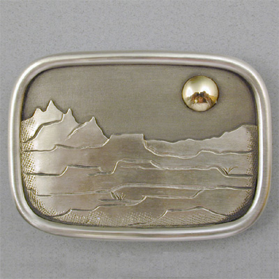 BU-1: Sterling silver and 18 karat gold belt buckle. For more information please call: (307) 382-3195