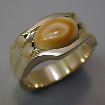 ER-29: The flowing design of this 18 karat gold ring is an appropriate framework for showing off your special elk ivory. ( $1,835.00 ) For more information please call: (307) 382-3195