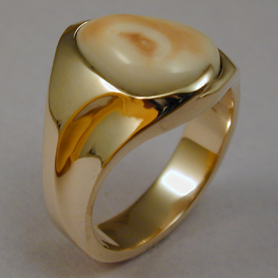 ER-3: A flowing contemporary design showcases this Rocky Mountain Elk Ivory in 18 karat yellow gold. ( $1,325.00 ) For more information please call: (307) 382-3195