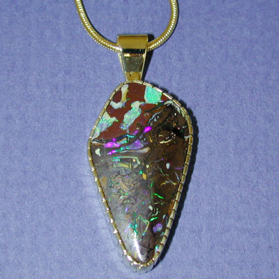 P-16: Made of 18 karat yellow gold this pendant accentuates a boulder opal from the small out- back town of Yowah. Yowah is about 600 miles west of Brisbane in the Australian state of Queensland. For more information please call: (307) 382-3195