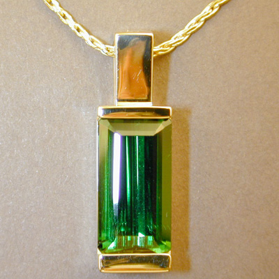 P-8: Green tourmaline and 18 karat gold are a nice combination for this pendant. For more information please call: (307) 382-3195