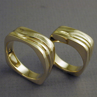R-160-240: These 18 karat gold rings make an excellent choice for matching wedding bands. Rings can be ordered separately. The squarish styling gives the rings a decidedly "custom made" look. ( $995.00 larger, $920.00 smaller ) For more information please call: (307) 382-3195