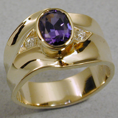 R-20: Eighteen karat gold and an exquisite oval cut Tanzanite stone make this a very elegant ring. The design is enhanced with two 5 point round brilliant cut diamonds. I am sure you know someone who would love to own this ring. Perhaps it is you! For more information please call: (307) 382-3195