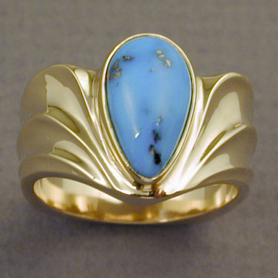 R-21: Kingman, Arizona gem turquoise hi-lites this contemporary designed ring made of 18 karat gold. A low profile ring such as this is easy to wear and doesn't catch on clothing. For more information please call: (307) 382-3195